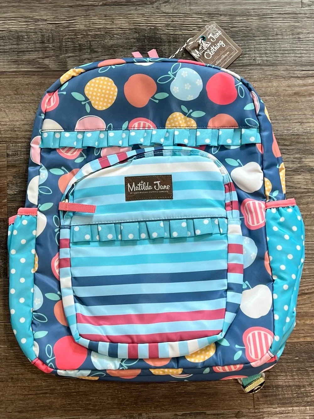 Matilda Jane NEW backpack featuring a colorful apple pattern & ruffled trim